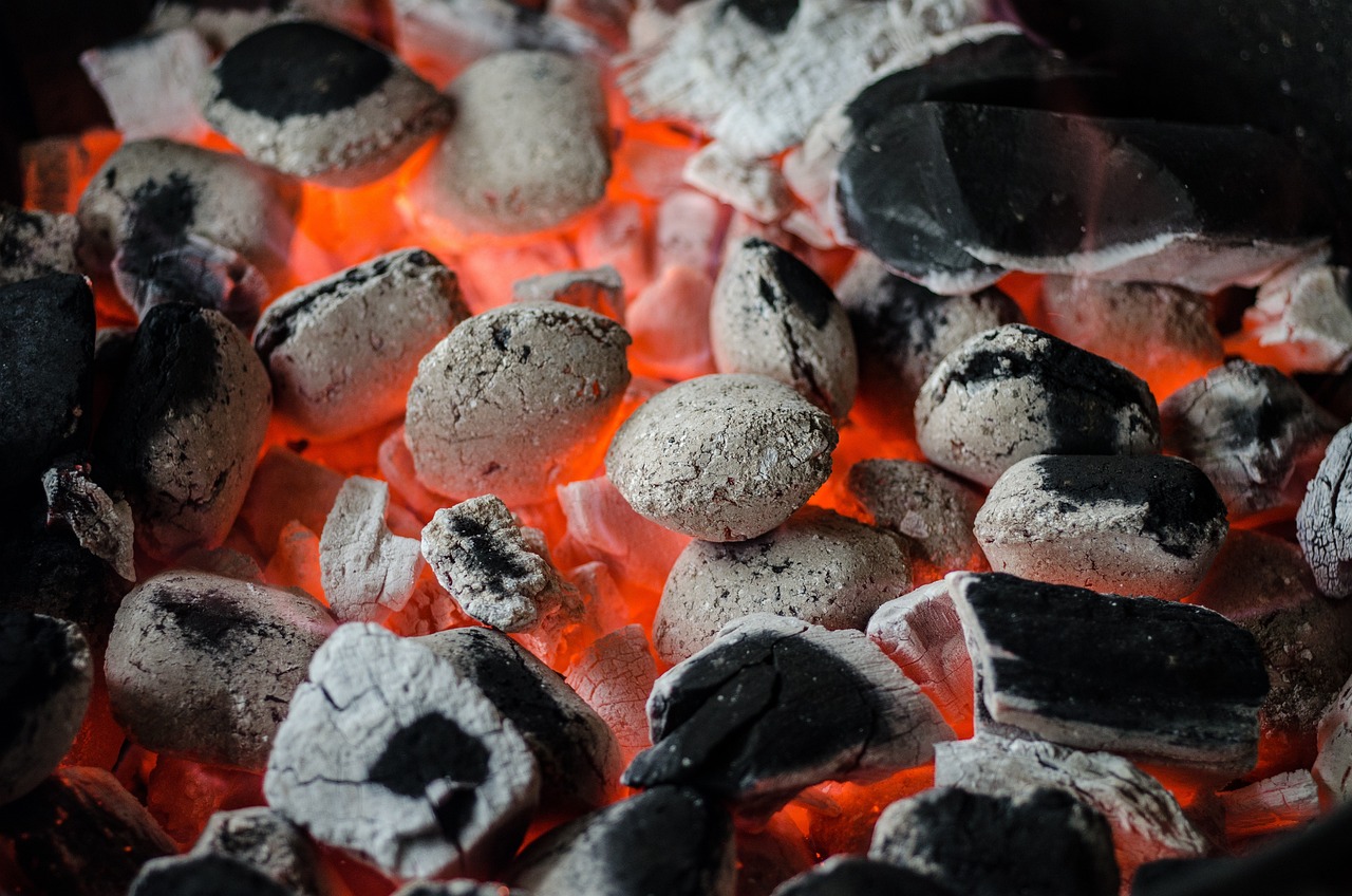 Close-up of glowing red charcoal used for slow-smoking BBQ in Charleston SC